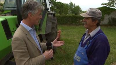 Tim Willcox speaks to a farmer in the Greek countryside