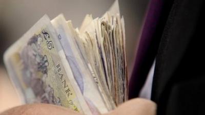 Man holding cash in his hand