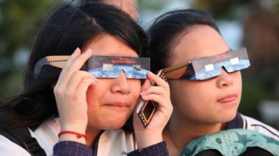 Children look through 'eclipse specs' to protect their eyes