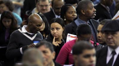 People wait in line at a job fair in the Queens borough of New York City