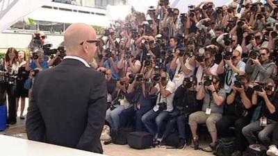 Bruce Willis in front of photograhers at Cannes