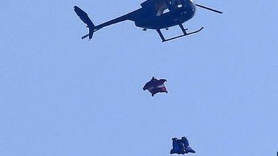 Wingsuit skydivers jump out of helicopter