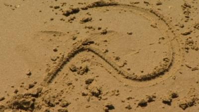 Question mark in sand