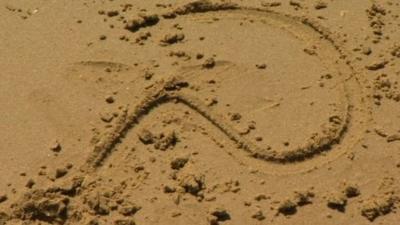 Question mark in sand