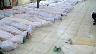 Bodies lying at a hospital morgue before their burial in the central Syrian town of Houla