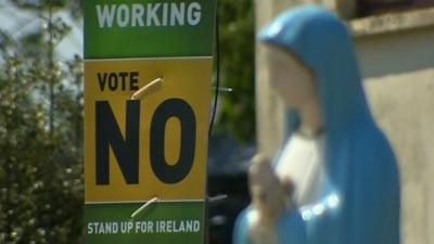 A sign telling people to vote against the new budget rules