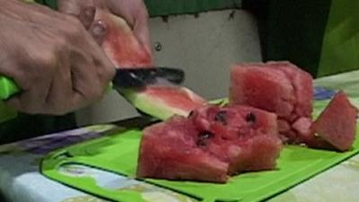 Cutting watermelon in a recycling workshop