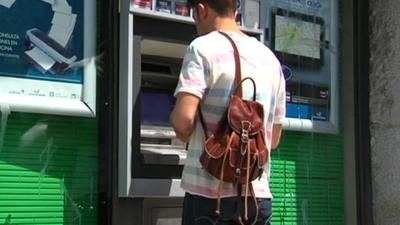Person at a cash machine in Spain