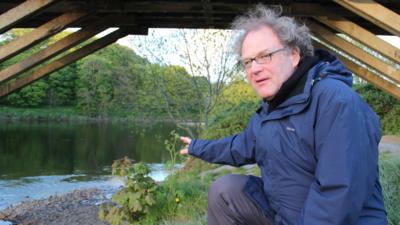 Aidan Turner-Bishop points to the spot on the River Ribble where the first Mormon baptisms in England took place