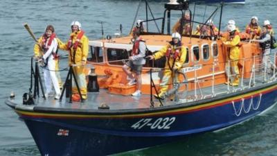 Olympic torch on a lifeboat