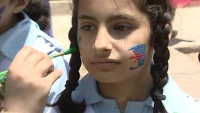 Girl's face being painted in Pakistan