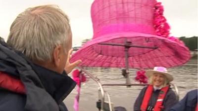 Large pink hat on boat