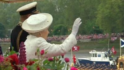 The Queen waves to crowds