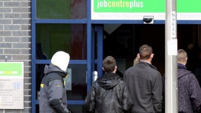 Young people queuing outside a job centre