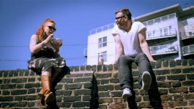 People sitting on a wall in Shoreditch