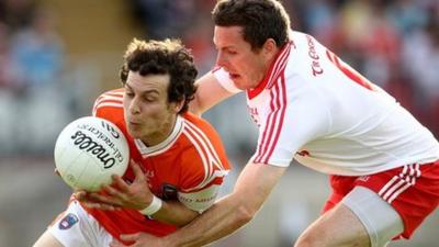 Armagh forward Jamie Clarke is tackled by Tyrone's Conor Gormley