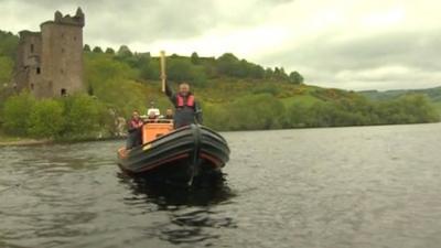 The Olympic torch is carried on a boat