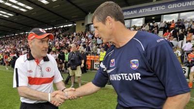 Paddy O'Rourke shakes hands with Mickey Harte at the Athletic Grounds