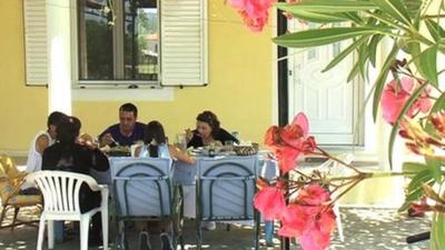 Greek family at dining table