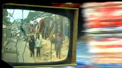 View in vehicle's wing mirror of Mogadishu street