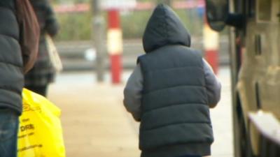 A boy walks the streets in London