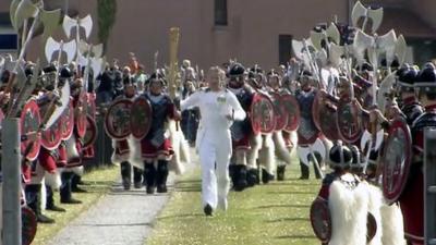 The Olympic torch surrounded by Vikings