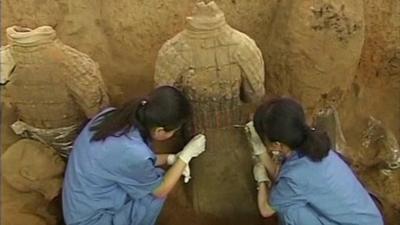 Archaeologists excavating a terracotta warrior