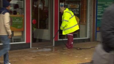 A man cleaning the street