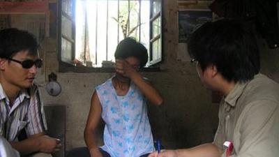 Chen Guangchen visiting with a victim of a forced abortion