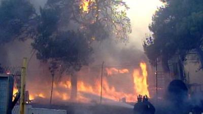 Fire crews try to put out wildfires in Greece