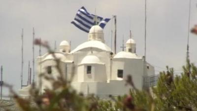 Greek flag flies on building