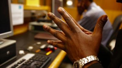 Hands resting by a keyboard