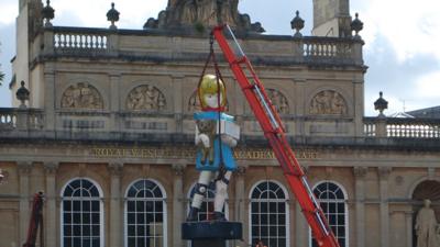 Two cranes being used to lift Charity onto a lorry