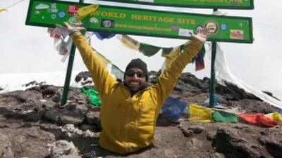 Spencer West at the top of Kilimanjaro