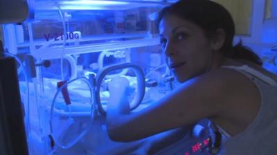 Mother of premature baby in incubator