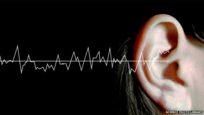 Sound waves graphic with woman's ear