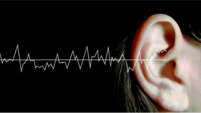 Sound waves graphic with woman's ear