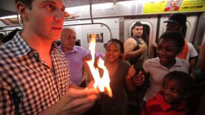 Man with fire on subway