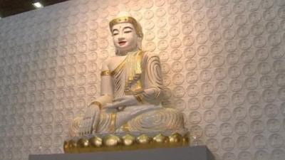 A statue of Buddha in the main prayer room of the temple