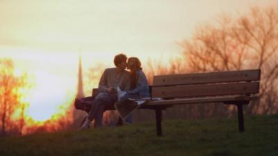 A couple kissing on Hampstead Heath