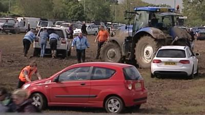 Cars stuck in the mud at the Isle of Wight Festival