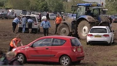 Cars stuck in the mud at the Isle of Wight Festival