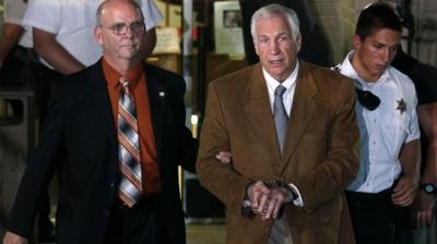 Jerry Sandusky led from court in handcuffs