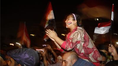 Girl on man's shoulders, celebrating