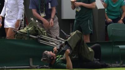 A BBC camerman falls over at Wimbledon