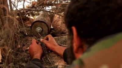 Syrian rebel fighter plants an IED