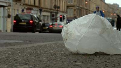 A discarded plastic bag lying in a street