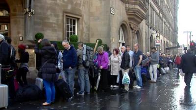 Rail passengers queue at Glasgow's Central Station