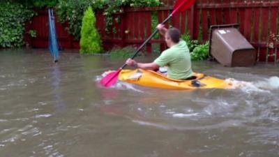 Man in canoe in back garden