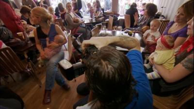 Breast-feeding mothers gather at a cafe in Bristol to protest against the way another mother was treated